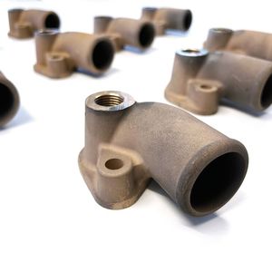 Die 3D-gedruckten Bronzekrümmer übertreffen die Anforderungen an das Originalteil.(Bild:  MAN Truck & Bus)