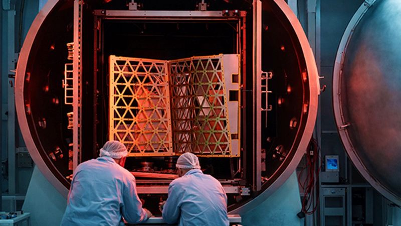 Two scientists in front of a vacuum chamber used for testing.(Source:  Busch Group)