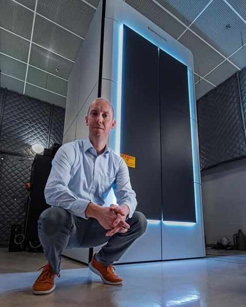 ORNL’s David Cullen stands in front of the new Thermo Scientific Spectra Ultra transmission electron microscope. (Source: ORNL/ Carlos Jones, U.S. Dept. of Energy)