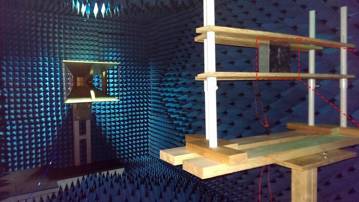 The researchers tested their metamaterial-based antenna in an anechoic chamber. The radio wave is sent out from the horn antenna on the left and received by the metasurface antenna mounted on the wood frame on the right. (Jiangfeng Zhou and Clayton Fowler)