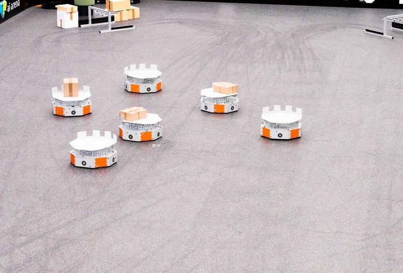 Ein Rudel Loadrunner mit und ohne „Gepäck“, bei einem Praxistest. Die Lastabgabe wird durch das Abbremsen der Roboter initiiert, erklärt das IML – also durch Trägheiskräfte. (Fraunhofer-IML)