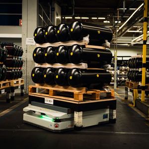 With centimeter precision, the KMP 1500P delivers 100-liter compressed air tanks to a welding station.(Image: Kuka)