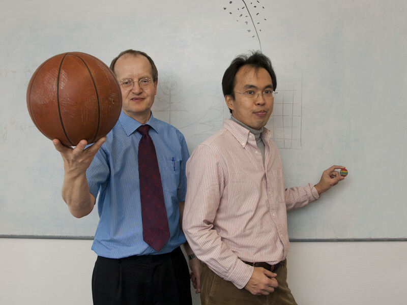 Prof. Joachim Burgdörfer (l.) und Shuhei Yoshida (r.) demonstrieren das Zusammenspiel von Sonne und Jupiter. (Maßstabsgerecht wäre der Abstand zwischen den Himmelskörpern allerdings viel größer.)  (Bild: TU Wien)