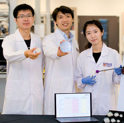 Assoc Prof Benjamin Tee (centre), together with Dr Cheng Wen (left) and Ms Wang Xinyu (right), have developed a novel aero-elastic pressure sensor, called ‘eAir’ (gold strips on the panel held by Assoc Prof Tee).